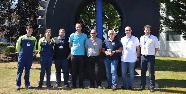 Les participants à la formation + Babbage :) posent devant le pneu présenté à l'entrée de l'usine